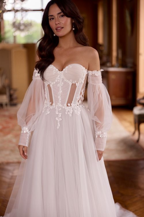 Tulle corset wedding dress featuring sheer side cut-outs by Elizabeth Passion.